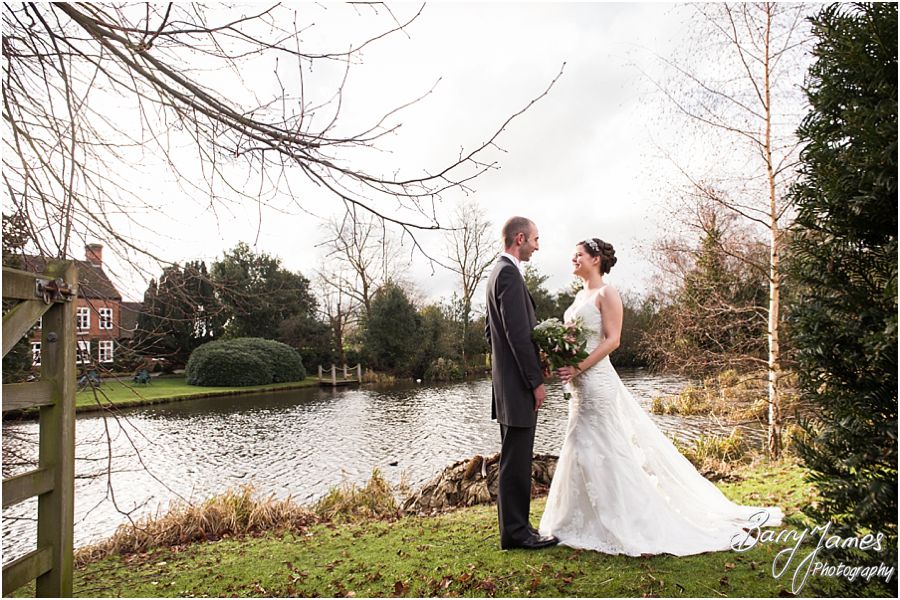 Creative personal portraits of bride and groom by the lake at The Moat House in Acton Trussell by Stafford Wedding Photographer Barry James