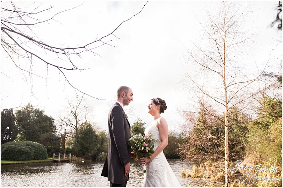Contemporary stunning portrait photographs of bride and groom by the lake at The Moat House in Acton Trussell by Stafford Wedding Photographer Barry James