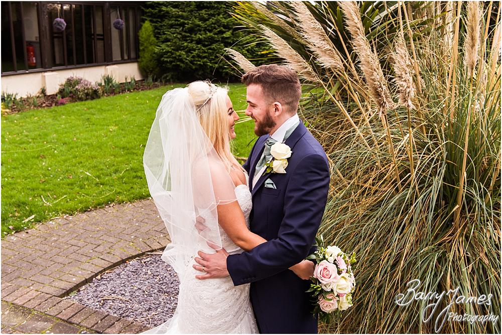 Creative and relaxed portraits of the bride and groom around the beautiful gardens at Oak Farm Hotel in Cannock by CannockWedding Photographer Barry James