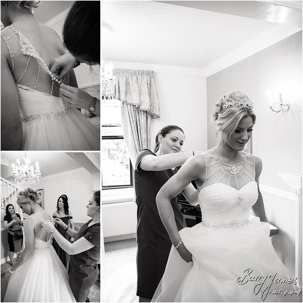 Dressing of the bride in her beautiful gown from Robertas Bridal of Burslem at Hoar Cross Hall in Staffordshire by Stafford Wedding Photographer Barry James