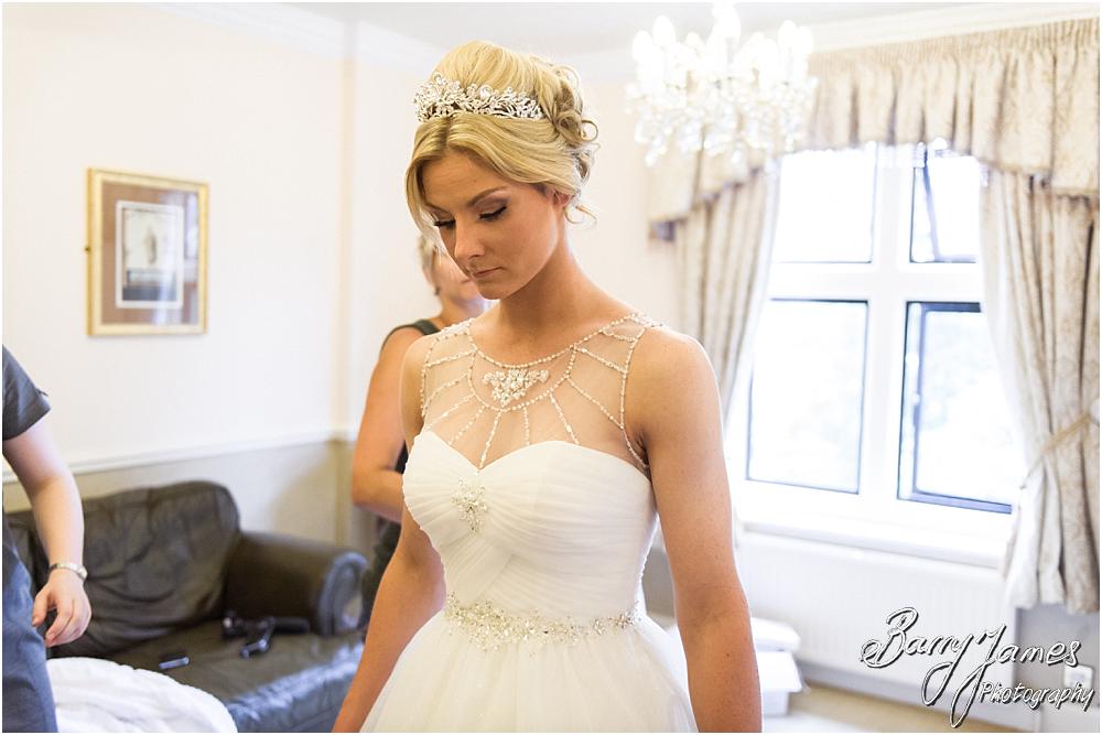 Dressing of the bride in her beautiful gown from Robertas Bridal of Burslem at Hoar Cross Hall in Staffordshire by Stafford Wedding Photographer Barry James