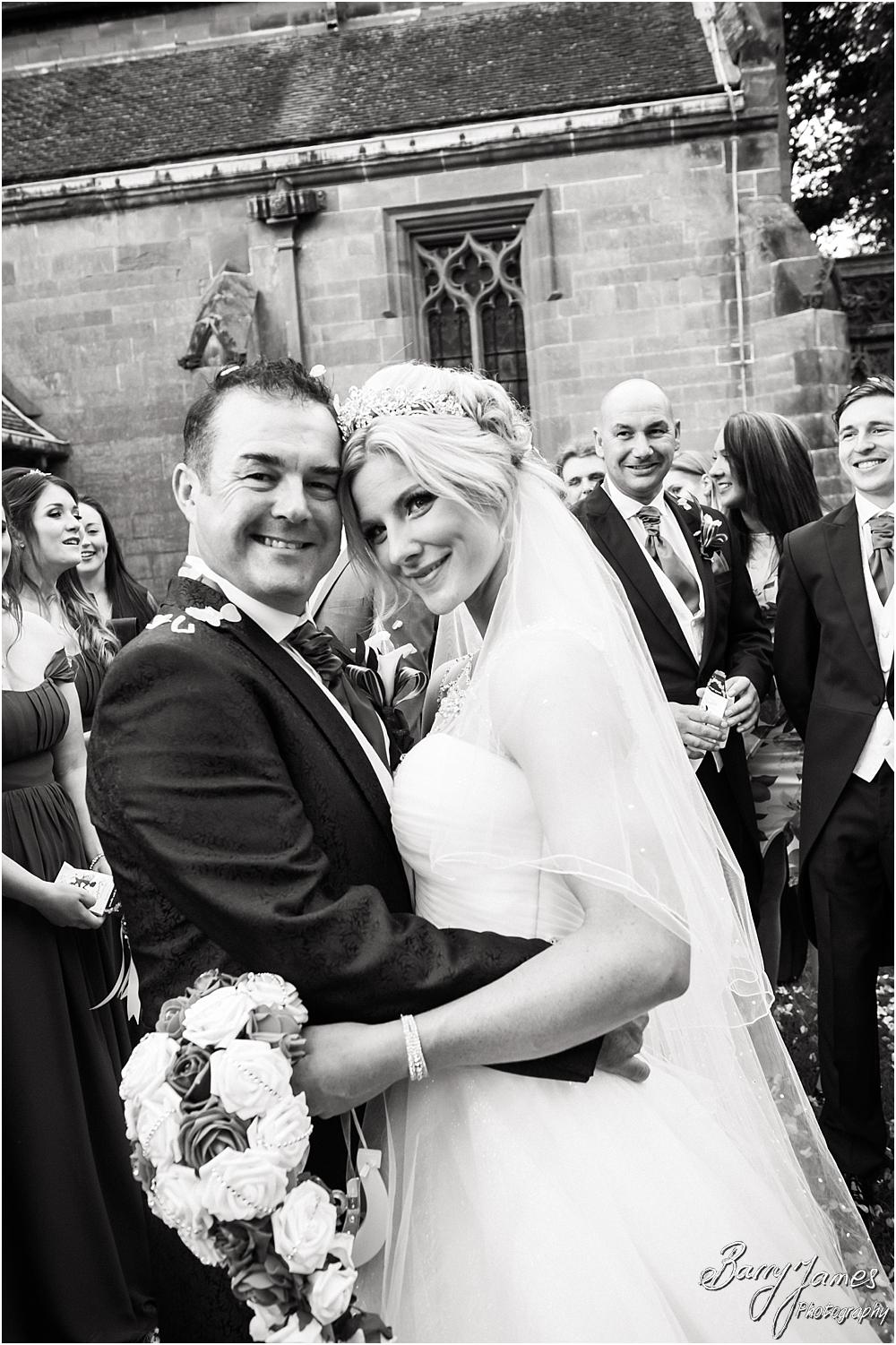 Confetti fun at Holy Angels Church at Hoar Cross Hall in Staffordshire by Stafford Wedding Photographer Barry James