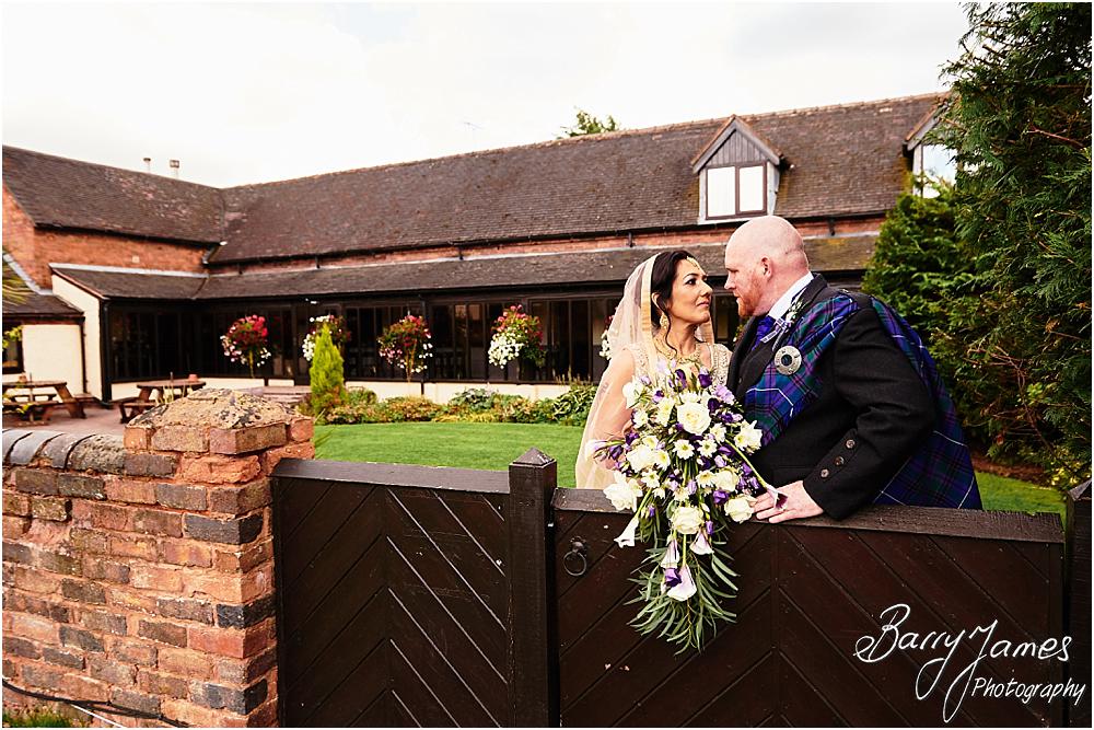 Creative portraits of the bride and groom in the stunning front gardens at Oak Farm Hotel in Cannock by Cannock Wedding Photographer Barry James