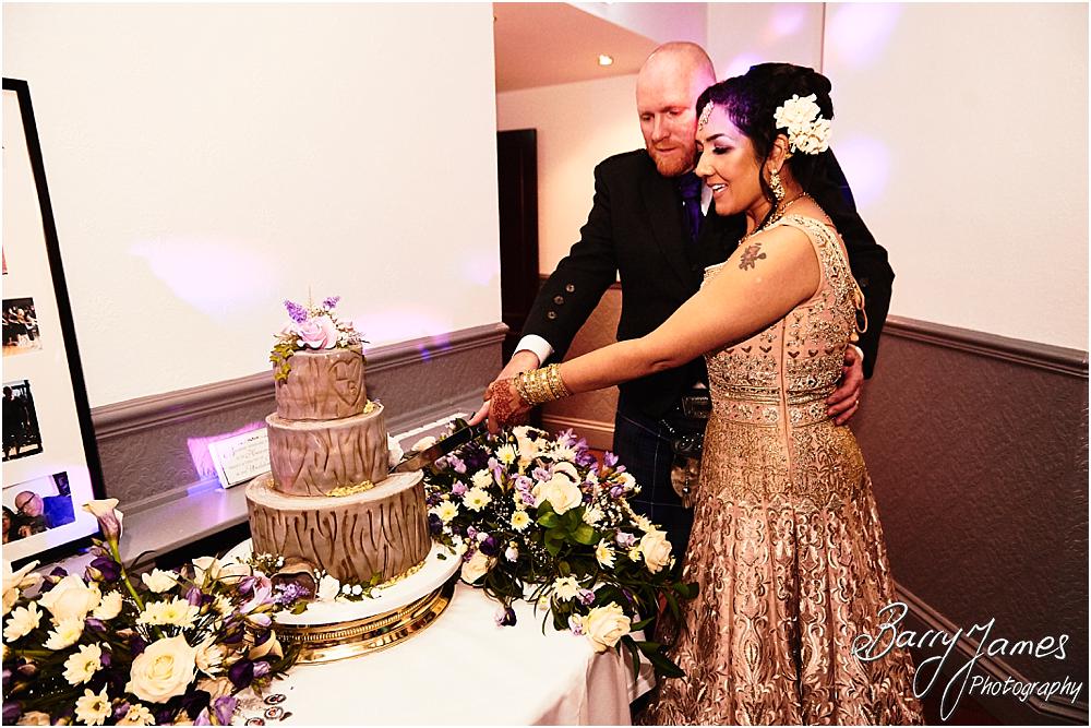 Cake cutting fun for the bride and groom at Oak Farm Hotel in Cannock by Cannock Wedding Photographer Barry James